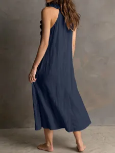 Back view detail of the navy blue sleeveless ruffle maxi dress. Flowy hemline summer style.