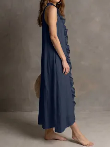 Detailed view of solid navy blue sleeveless long dress with elegant front ruffle and hem.