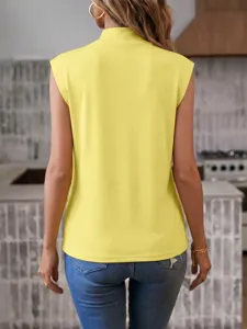 Back view detail of a casual yellow sleeveless top featuring a mock neck and blue jeans.