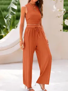 Detailed view of women's solid ribbed two-piece crop top and wide-leg pants set.