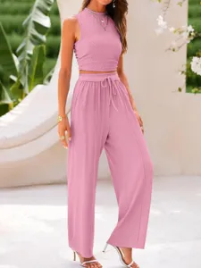 Solid pink ribbed two-piece set featuring a slim crop top and high-waisted wide-leg pants.