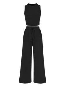 Solid color ribbed two-piece set, slim fit crop top tank and high-waist wide-leg pants detail.
