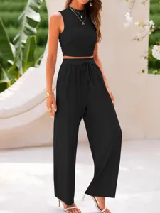 Detail view of the elegant black ribbed two piece set, featuring a crop top and pants.