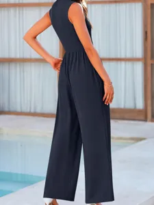 Detailed view of women's dark blue sleeveless wide-leg jumpsuit, stylish outdoor pool wear.