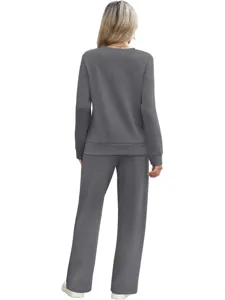 Casual two-piece lounge set featuring a long sleeve top and pants in dark grey. Detail view.