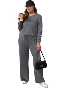 Grey lounge set detail showcasing pleated sweatshirt and comfortable drawstring trousers for daily wear.