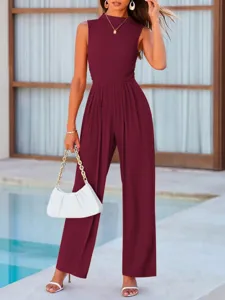 Outdoor poolside scene showcasing the stylish maroon sleeveless jumpsuit details and fit.