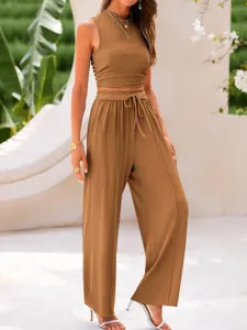 Solid color rib knit two piece set featuring a slim crop tank top and high waist wide leg pants.