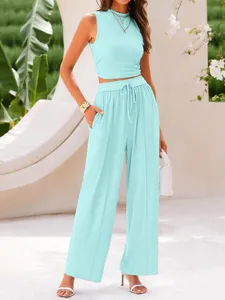 Light blue ribbed knit two-piece set featuring a slim fit crop top and high waist wide leg pants.