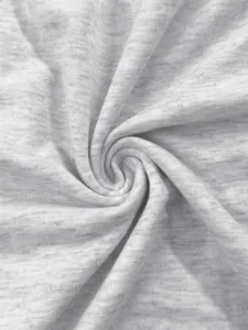 Close-up detail of soft light gray melange knit fabric texture with swirl pattern.