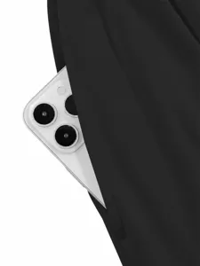 Close-up of black pants pocket detail showing smartphone storage convenience and fabric texture.