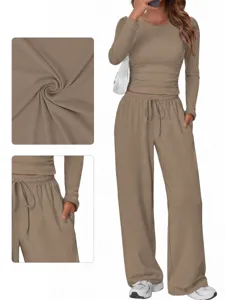 Casual solid long sleeve crop top and wide leg pants set, featuring pocket and fabric details.
