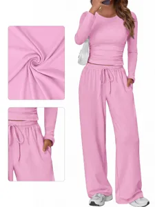 Pink lounge set detail view showing soft fabric texture, elastic waistband and deep pocket design.