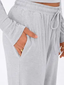 Close-up shot of the soft grey loungewear pants featuring an elastic drawstring waist and pocket.