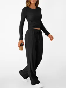 Detail view of women's black long sleeve top and loose casual pants two-piece loungewear set.