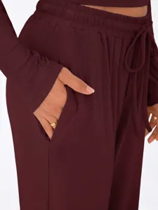 Burgundy casual loungewear pocket detail trousers and long sleeve top set close up view