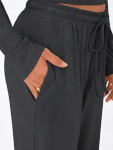 Dark grey ribbed lounge set detail, comfortable long sleeve top and wide leg pants with pocket.