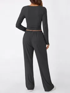 Back view detail of a dark grey long sleeve top and wide leg trousers loungewear set.
