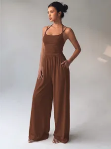 Detail view of the elegant brown sleeveless halter wide-leg jumpsuit, showcasing fluid fabric.