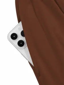 Close-up detail view of the pocket on a women's solid color casual jumpsuit with a phone.