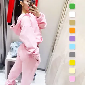 Pink crop zip hoodie and wide leg sweatpants set, stylish casual two piece athletic outfit.