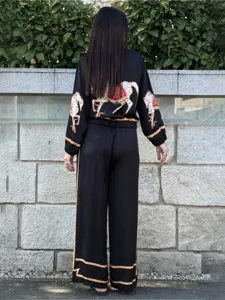 Detailed back view of the black two-piece set featuring exquisite horse print and contrast trim.