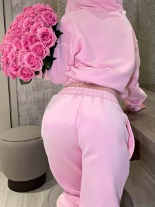 Detail view of the pink cropped zip hoodie and wide leg sweatpants set, casual chic.