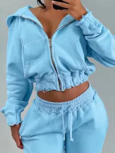 Light blue cropped zip hoodie and sweatpants set detail, raw edge casual streetwear style.