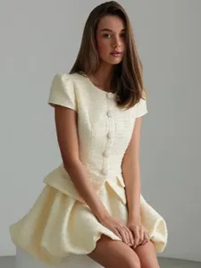 Detailed view of the ivory white tweed short sleeve mini dress, featuring classic style and cinched waist.
