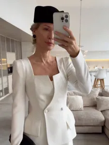 Detail view of the elegant white square neck blazer and skirt set, showcasing tailored fit and peplum.