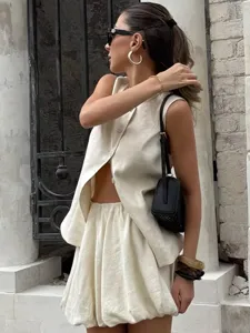 Beige sleeveless button vest and bubble mini skirt set detail view, chic two piece outfit.