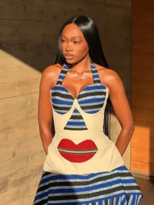 Chic retro resort two-piece set featuring striped halter top with red lip print and skirt.