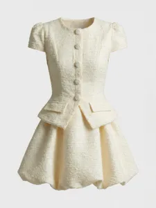 Detailed view of the ivory tweed dress, highlighting delicate buttons and bubble skirt shape.