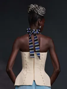 Detailed back view of a vintage style halter top with striped bow tie and corset design.