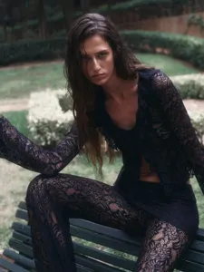 Outdoor garden detail shot of a black lace two-piece set featuring crop top and pants.
