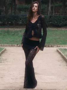 Detailed view of the black lace crop top and flare pants two-piece set with chic ruffles.