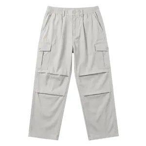 Detail view of light grey cargo pants, multi-pocket design, loose straight leg cut.