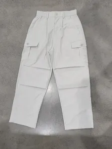Detail view of men's loose cargo pants featuring multiple pockets and durable fabric construction.