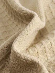 Close-up van tricot stof textuur voor heren truien, zacht gebreid materiaal met detail