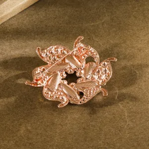 Detailed view showing the secure pin mechanism and textured back of a rose gold flower brooch.