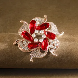 Detailed view of elegant flower brooch pin with red rhinestones and sparkling crystals for women