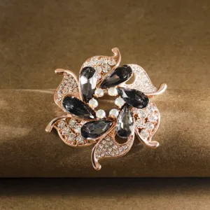 Exquisite rose gold flower brooch detail, sparkling crystal rhinestones and dark teardrop stones.