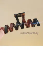 Brown geometric hair claw clip for thick hair, stylish zigzag shark clip for women styling.
