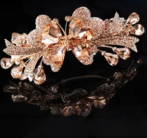 Detailed close-up of luxurious champagne crystal rhinestone butterfly hair clip sparkle.