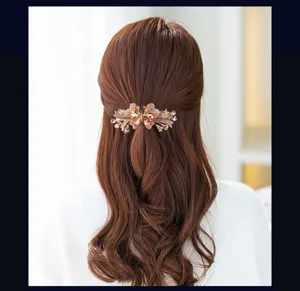 Detailed view of elegant floral rhinestone hair clip, secure spring barrette for half-up hairstyles.