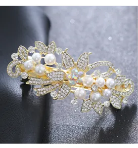 Stunning detail close-up of a gold-tone pearl and rhinestone floral hair clip spring barrette.