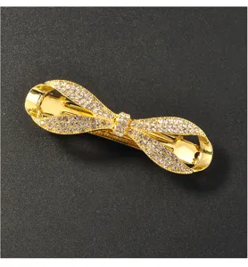 Gold rhinestone bow spring hair clip detail shot, elegant crystal hair accessory for women.