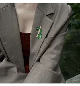 Luxury emerald-imitation zircon bamboo brooch designer elegant corsage accessory detailing.