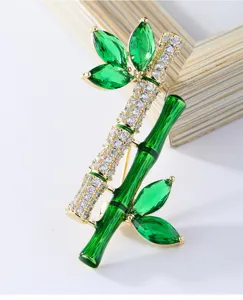 Elegant Chinese style bamboo brooch with green cubic zirconia and sparkling crystals for apparel.