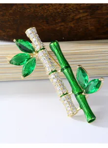 Detailed view of the luxury emerald zirconia bamboo brooch, elegant designer clothing accessory.